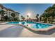Sparkling community pool with surrounding patio furniture, under a clear sky at 632 Edgewater Dr # 439, Dunedin, FL 34698