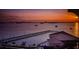 Stunning sunset over the water, with a pier and clubhouse visible at 632 Edgewater Dr # 439, Dunedin, FL 34698