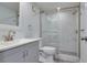 Updated bathroom with walk-in shower and gray vanity at 7050 Sunset S Dr # 211, South Pasadena, FL 33707