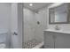 Updated bathroom with a marble shower and gray vanity at 7050 Sunset S Dr # 211, South Pasadena, FL 33707