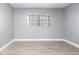 Empty bedroom with wood flooring and window at 7050 Sunset S Dr # 211, South Pasadena, FL 33707
