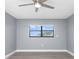 Bright bedroom featuring a ceiling fan and large window at 7050 Sunset S Dr # 211, South Pasadena, FL 33707