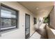 A hallway with light walls, tiled floors, and a door to a condo at 7050 Sunset S Dr # 211, South Pasadena, FL 33707