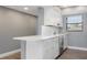 Modern kitchen with white cabinets, stainless steel appliances, and quartz countertops at 7050 Sunset S Dr # 211, South Pasadena, FL 33707