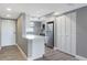 Modern galley kitchen with white cabinets and gray walls at 7050 Sunset S Dr # 211, South Pasadena, FL 33707