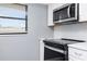 Kitchen with stainless steel appliances and white cabinets at 7050 Sunset S Dr # 211, South Pasadena, FL 33707