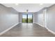 Spacious living room with grey walls and wood-look floors at 7050 Sunset S Dr # 211, South Pasadena, FL 33707
