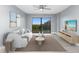 Living room with a modern sofa, TV, and access to a balcony at 7050 Sunset S Dr # 211, South Pasadena, FL 33707