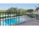 Balcony view of a community pool and lush landscaping at 7050 Sunset S Dr # 211, South Pasadena, FL 33707