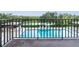 View from balcony of a refreshing pool with lounge chairs at 7050 Sunset S Dr # 211, South Pasadena, FL 33707
