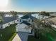 Two-story house with lake view, driveway, and landscaped lawn at 8111 Tar Hollow Dr, Gibsonton, FL 33534
