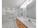 Updated bathroom with double sinks and marble shower at 8111 Tar Hollow Dr, Gibsonton, FL 33534