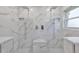 Large bathroom with double shower heads and marble tile at 8111 Tar Hollow Dr, Gibsonton, FL 33534