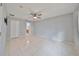 Large bedroom with tile floors and access to another room at 8111 Tar Hollow Dr, Gibsonton, FL 33534