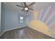 Bedroom with ceiling fan and sunny wall art at 8111 Tar Hollow Dr, Gibsonton, FL 33534