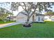 Two-story house with attached garage and landscaped lawn at 8111 Tar Hollow Dr, Gibsonton, FL 33534