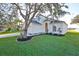 Two-story house with attached garage and landscaped lawn at 8111 Tar Hollow Dr, Gibsonton, FL 33534