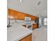 Kitchen with wood cabinets, white countertops, and arch window at 8111 Tar Hollow Dr, Gibsonton, FL 33534