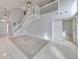 Spacious living room with high ceilings, staircase, and tile floors at 8111 Tar Hollow Dr, Gibsonton, FL 33534