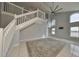 Spacious living room with high ceilings, a ceiling fan, and large windows at 8111 Tar Hollow Dr, Gibsonton, FL 33534
