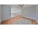 Loft area overlooking the living room with wood flooring and ceiling fan at 8111 Tar Hollow Dr, Gibsonton, FL 33534