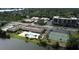 Aerial view of condo community with pool, tennis courts, and waterfront access at 9860 62Nd N Ter # 1013, St Petersburg, FL 33708