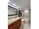 Bathroom with granite countertop, wooden cabinets and bathtub at 9860 62Nd N Ter # 1013, St Petersburg, FL 33708