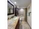 Bathroom with granite countertop, wooden cabinets and bathtub at 9860 62Nd N Ter # 1013, St Petersburg, FL 33708
