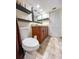 Clean bathroom with wood cabinets, granite countertop, and updated tile flooring at 9860 62Nd N Ter # 1013, St Petersburg, FL 33708