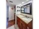 Bathroom with granite countertop, wooden cabinets and sink at 9860 62Nd N Ter # 1013, St Petersburg, FL 33708