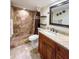 Updated bathroom with a shower, toilet, vanity with granite countertop, and a large mirror at 9860 62Nd N Ter # 1013, St Petersburg, FL 33708