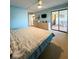 Spacious bedroom with large bed, dresser, and access to patio at 9860 62Nd N Ter # 1013, St Petersburg, FL 33708