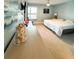 Main bedroom with king bed, dresser, and calming ocean-themed decor at 9860 62Nd N Ter # 1013, St Petersburg, FL 33708