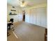Bedroom with large closet, ceiling fan, and access to hallway at 9860 62Nd N Ter # 1013, St Petersburg, FL 33708