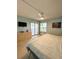 Bright bedroom with a large bed, dresser, and access to a balcony at 9860 62Nd N Ter # 1013, St Petersburg, FL 33708
