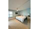 Bright bedroom with a king-size bed, nightstands, and ceiling fan at 9860 62Nd N Ter # 1013, St Petersburg, FL 33708