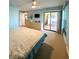 Spacious bedroom with a king-size bed, dresser, and access to a private balcony at 9860 62Nd N Ter # 1013, St Petersburg, FL 33708