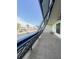 Enclosed patio with seating and view of street and palm trees at 9860 62Nd N Ter # 1013, St Petersburg, FL 33708