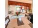 Open kitchen with wood cabinets and passthrough to dining area at 9860 62Nd N Ter # 1013, St Petersburg, FL 33708