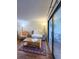 Living area with hardwood floors and access to balcony at 9860 62Nd N Ter # 1013, St Petersburg, FL 33708