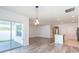 Open dining area with vinyl plank flooring and sliding glass doors to the patio at 10205 Golden Light Ct, Riverview, FL 33578