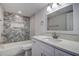 Modern bathroom with white vanity and geometric tile at 10237 Carrin Rd, Spring Hill, FL 34608