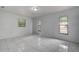 Spacious bedroom with tile floors and large windows at 10237 Carrin Rd, Spring Hill, FL 34608