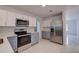 Modern kitchen with stainless steel appliances and gray shaker cabinets at 10237 Carrin Rd, Spring Hill, FL 34608
