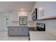 Updated kitchen with stainless steel appliances and gray cabinets at 10237 Carrin Rd, Spring Hill, FL 34608