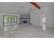 Bright living room with stone fireplace and sliding glass doors leading to patio at 10237 Carrin Rd, Spring Hill, FL 34608