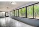 Bright sunroom with tile floors and large windows offering a view of the backyard at 10237 Carrin Rd, Spring Hill, FL 34608