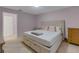 King-size bed in spacious bedroom with adjacent bathroom at 11511 113Th St # 13H, Largo, FL 33778