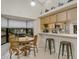 Bright dining area with wood table and chairs, open to kitchen at 11511 113Th St # 13H, Largo, FL 33778