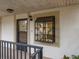 Exterior view of condo building, showing entrance with a window and a small balcony at 11511 113Th St # 13H, Largo, FL 33778
